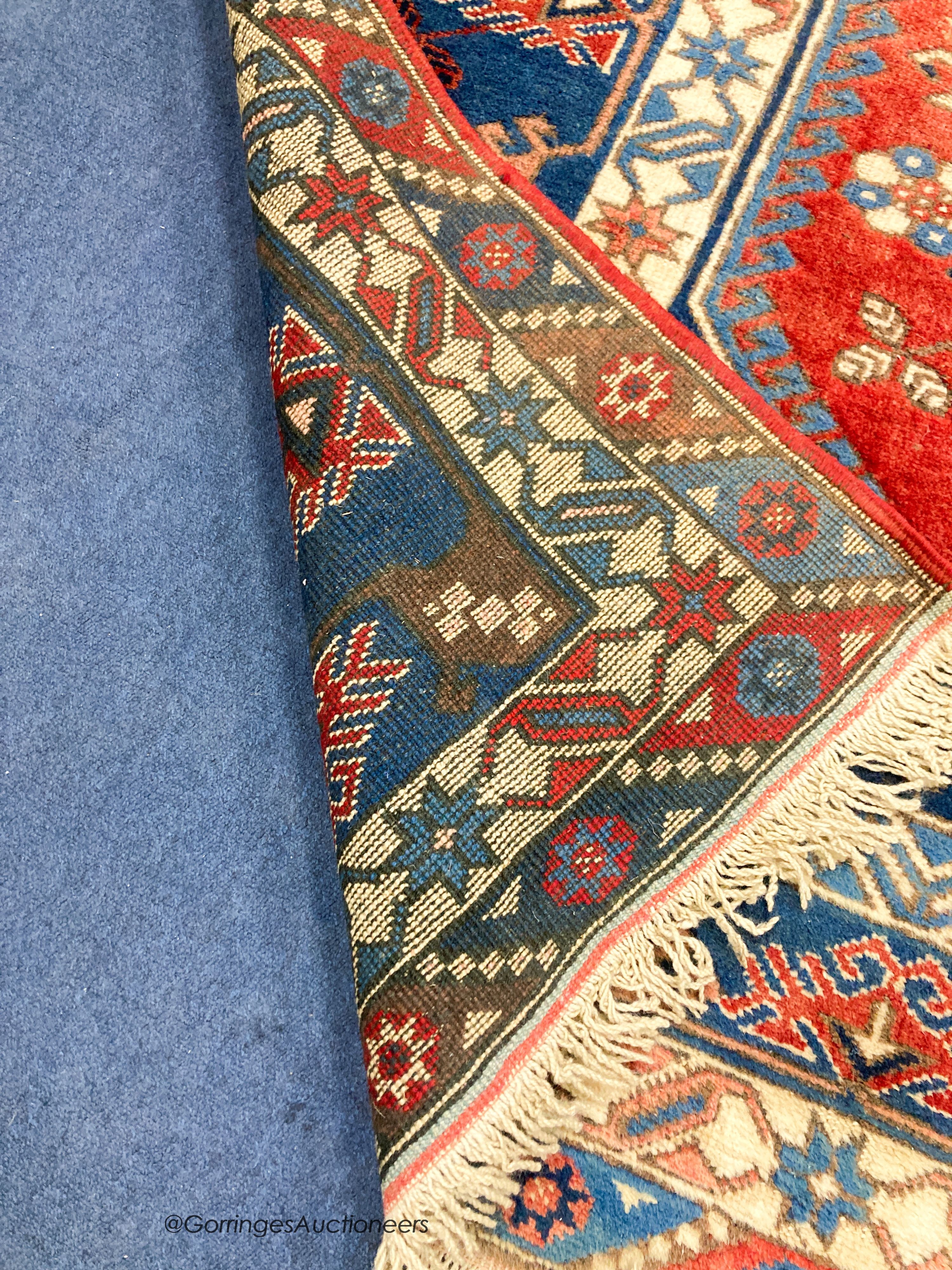 A Caucasian design blue ground rug, 240 x 152cm